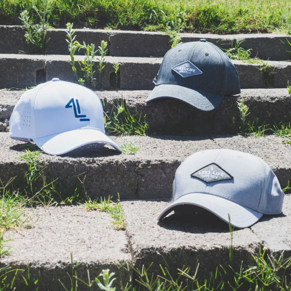 Three styles of Links Life Hats on stone stairs