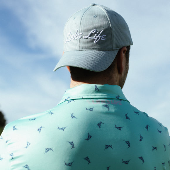 Man in blue Links Life Golf Polo and Links Life Hat